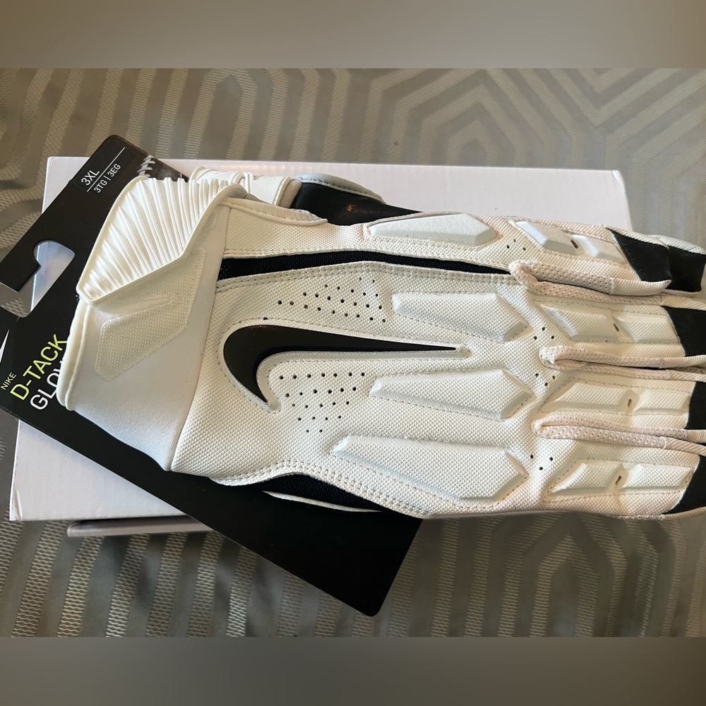 Brand new in package, NIKE D-TACK football GLOVES. Black and white. Size 3XL